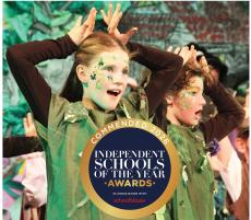 children acting on a stage in costumes