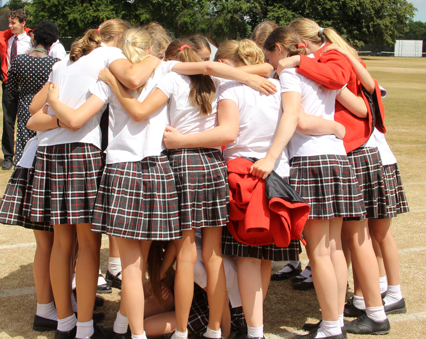 girls hugging in a field