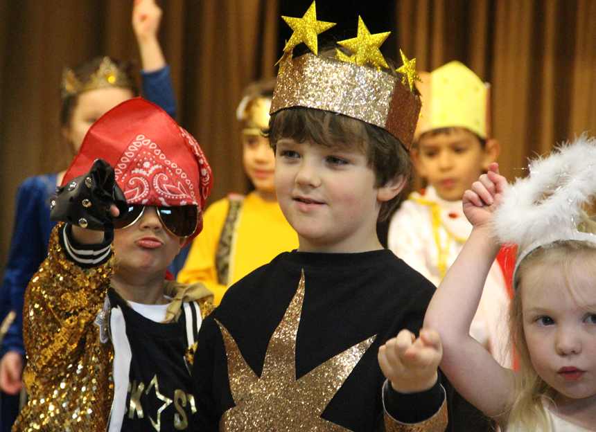 children dressed up on the stage acting
