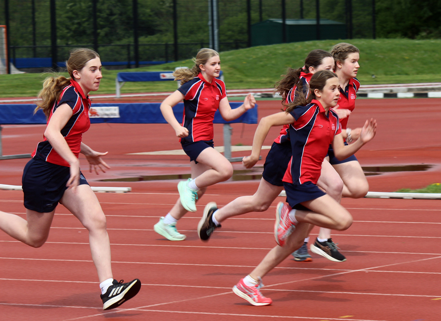 girls racing along an athletics track