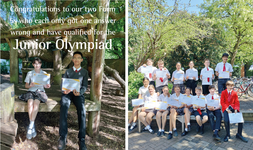 children sitting on a bench holding up winning certificates