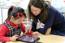 Student and teacher looking at a tablet