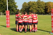 boys hugging on a rugby pitch