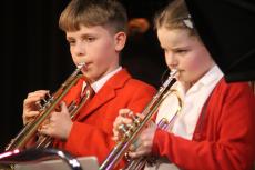 two children playing the trumpet