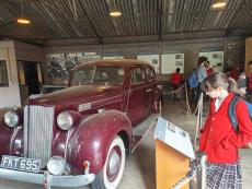 girl looking at old car at bletchley park