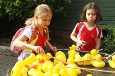 two girls playing hook a duck