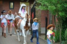 girl riding a horse in school