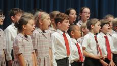 children singing on a stage
