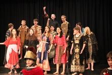 group of pupils standing on stage facing the audience