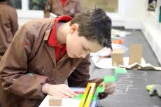 child using a strip heater to make a model
