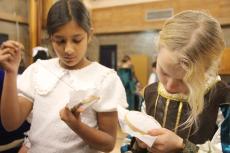 2 girls sewing in Tudor dress