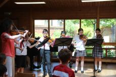 pupils performing on instruments at a concert