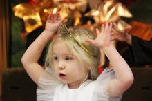 girl dressed in an angel costume singing