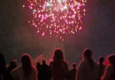 children watching red fireworks