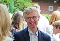 headmaster smiling talking to parents outside