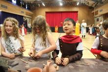 4 children dress in Roman costumes