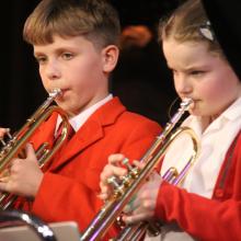 two children playing the trumpet