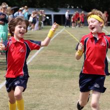 two boys crossing the finishing line on a race