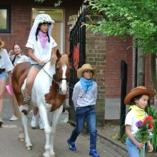 girl riding a horse in school