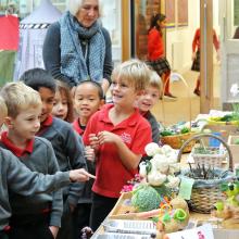 children looking at harvest produce