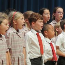 children singing on a stage