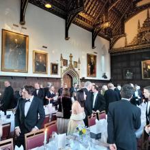 guests at a smart dinner in a college hall