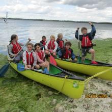 A group of children in canoes