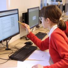 girl working at a desk on a computer