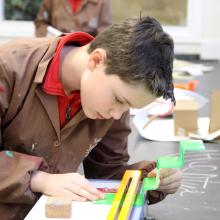 child using a strip heater to make a model