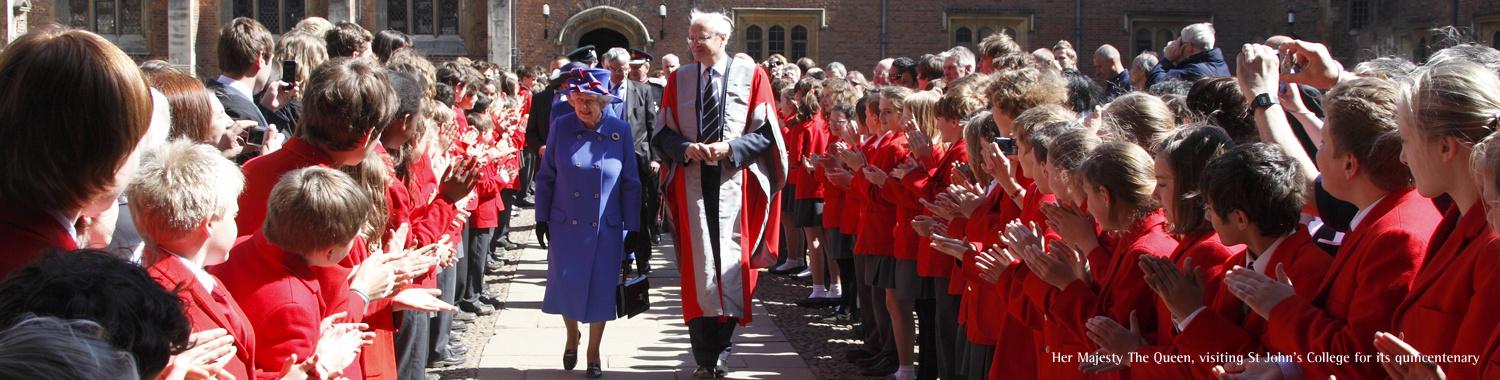 The queen walking through a crowd of children