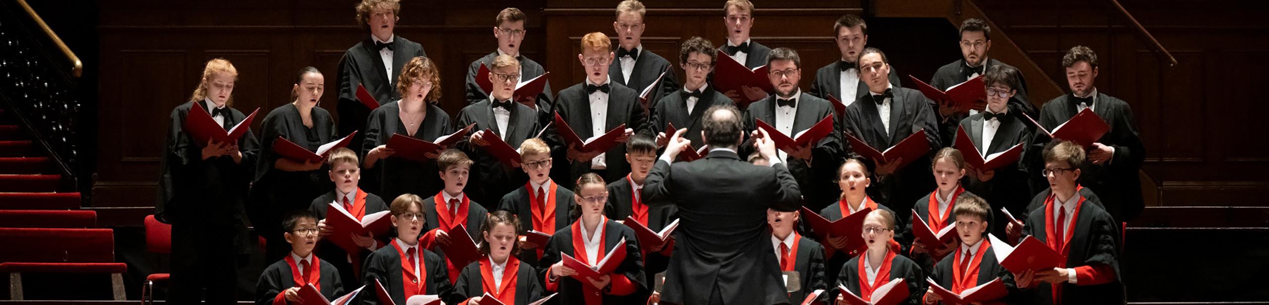 choir singing with conductor standing in front of them