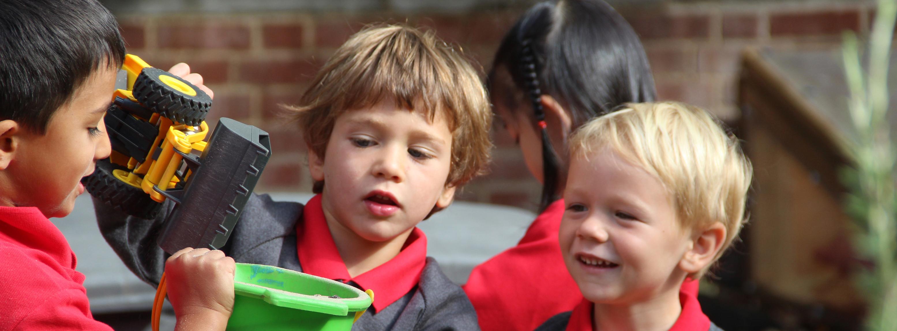 children playing with a bucket outside